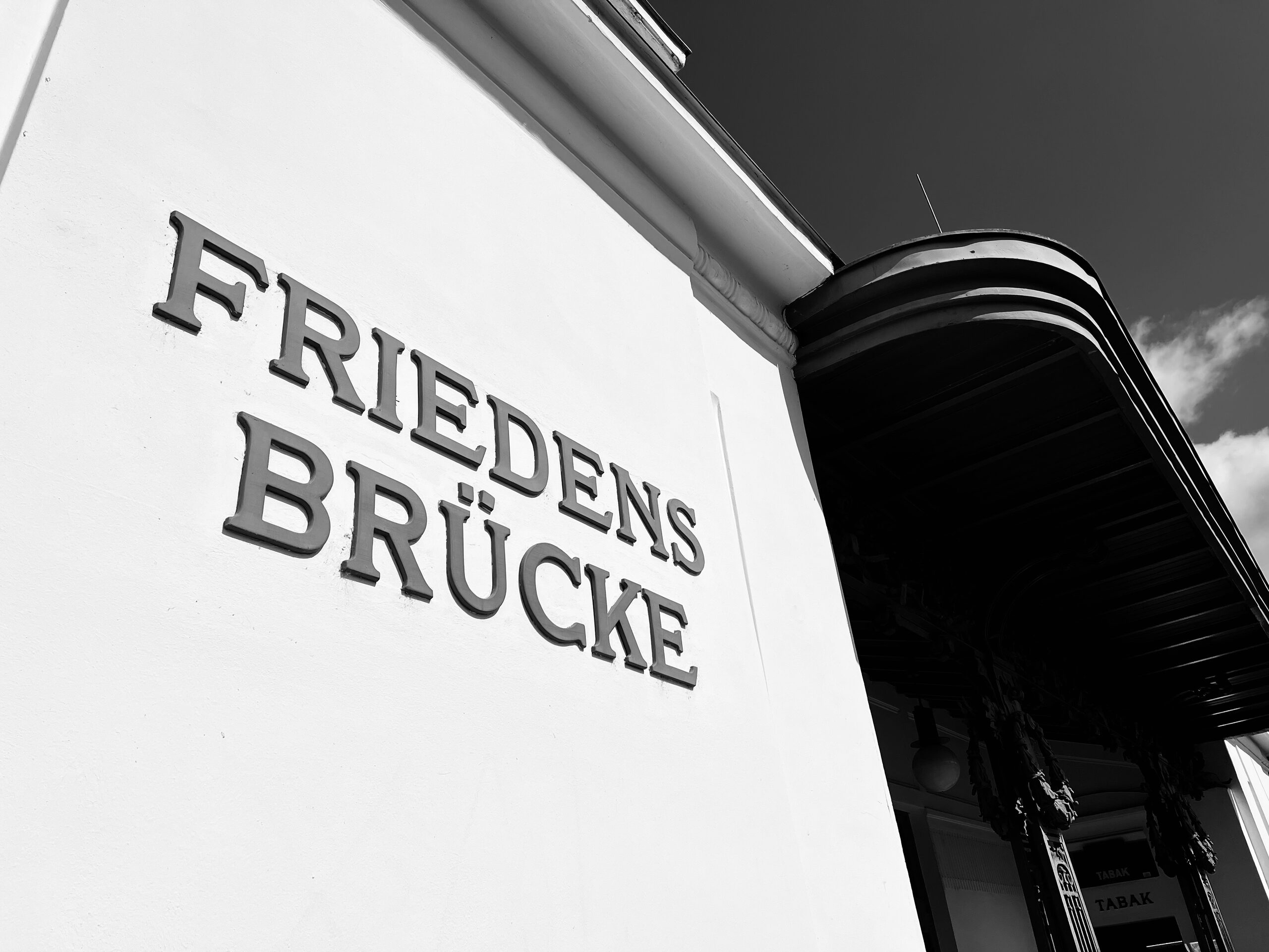 The name “Friedensbrücke” carved in stone on the side of the bridge.